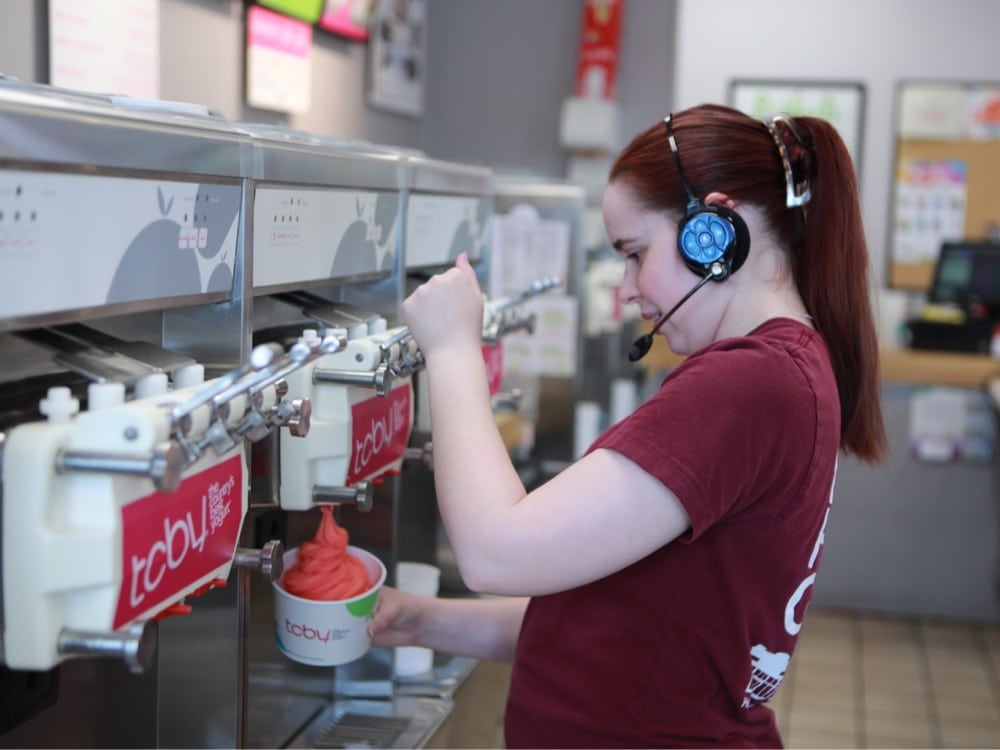 TCBY Staff filling frozen yogurt bowl